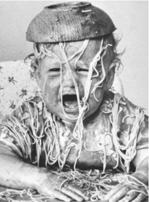 Crying baby covered in spaguetti